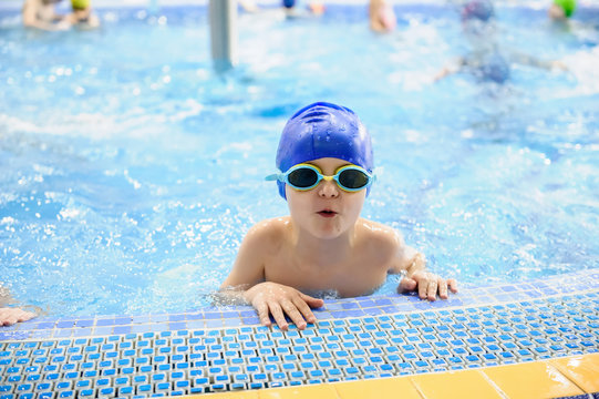 a 6-year boy swims in a swimming pool for kids
