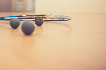 squash rackets and balls on court