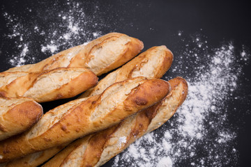 Close-Up Of Baguettes on cutting board with knife