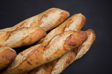 Hand made French bread selection on black background with copy area