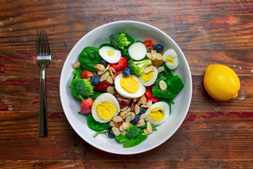 Top view of colorful healthy salad with fork