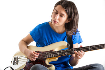 Beautiful rock girl playing bass guitar