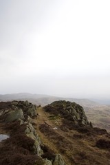 Fototapeta na wymiar Craggy rocky moorland with misty hills