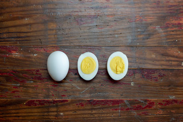 Hard boiled egg on rustic wood background