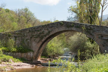 Fototapeta na wymiar Roman bridge crossing the Hijar river in Entrambasaguas