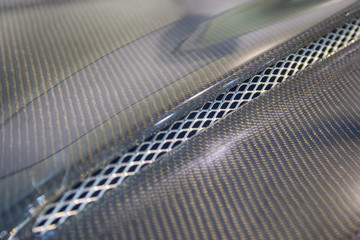 Black carbon car hood close up. Tuning