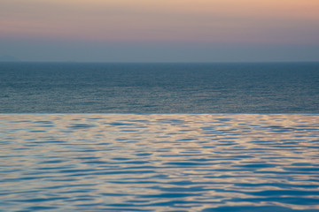 infinity swimming pool with ocean background
