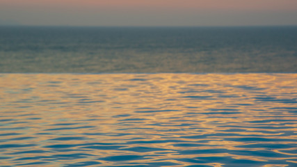 infinity swimming pool with ocean background