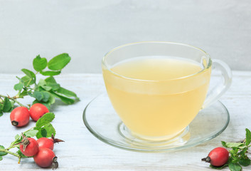 Rosehip tea in glass cup on the wooden table