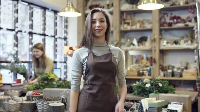 the girl in the apron in tern shows her thumbs