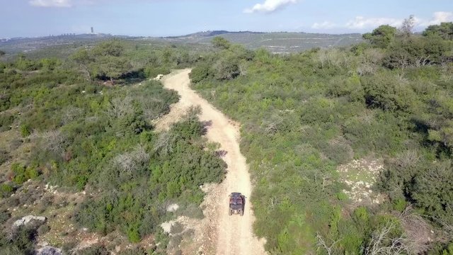 Buggy in a green forest - Top down aerial footage following the buggy along the trail.