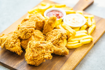 Fried chicken wings with french fries and tomato or ketchup and mayonnaise sauce