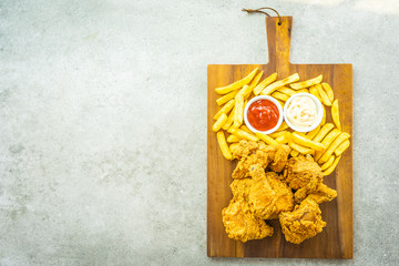 Fried chicken wings with french fries and tomato or ketchup and mayonnaise sauce