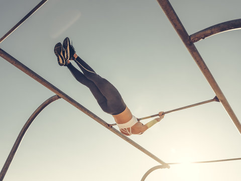 woman workout swinging on beach