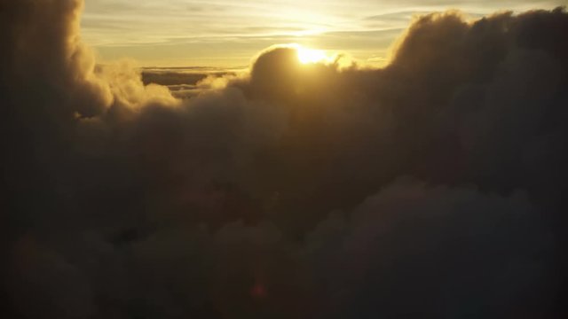 Aerial above cloud setting sun view Mauna Kea