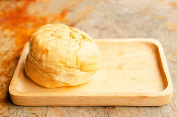 Thai tea Custard Bread on wood plate with macro close up