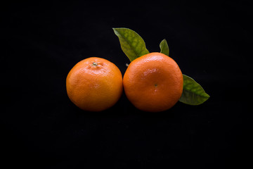 Ripe mandarin with leaves close-up on a white background.Tangerine orange with leaves on a white background.
