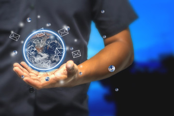 Concept of Businessman E-mail holds a simulated world that still communicates with e-mail.This element of the picture is decorated by Nasa.
