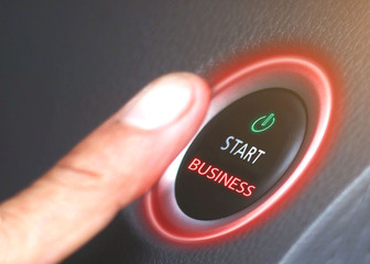 Push the business start button on a black background, red light, symbol of new business, business concept.