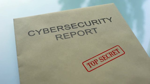 Cybersecurity report top secret, hand stamping seal on folder with documents