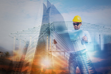 Construction concept, exposure of engineer talking looking on blueprint  with tower and building background