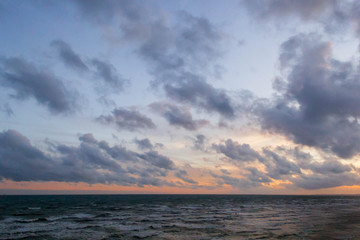 View of sea with sunset sky background