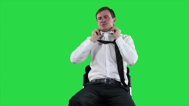 Tired businessman on green screen.