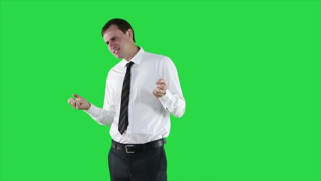 Satisfied businessman in white shirt on green background. Emotions are running.