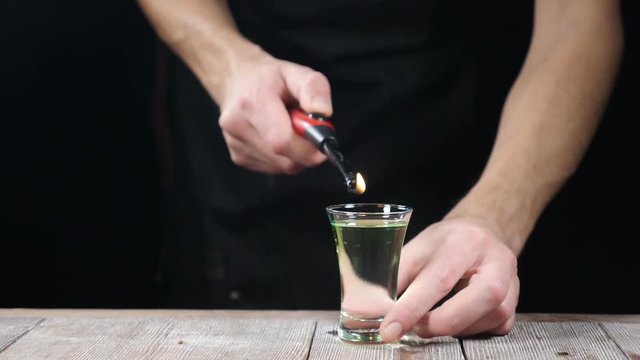 Nightclub life. Bartender sets fire to cocktail, burning cinnamon in alcohol drink, 180 frames per second, barman makes drink. Slow motion. hd