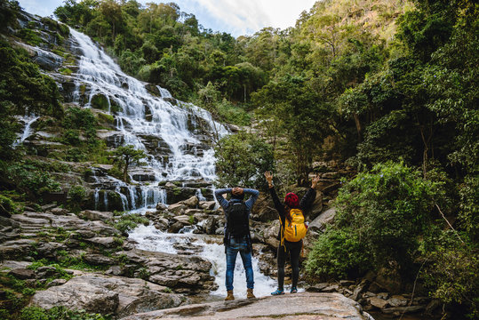 Couples traveling to relax, see nature, waterfall mae ya during the holidays at chiangmai in thailand.