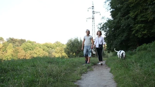 Walking in the forest.  Family's on vacation in the forest is getting to know to the natural world. 