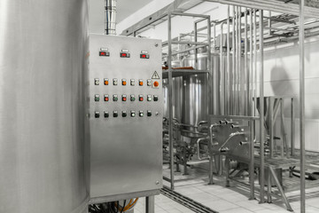 electronic control panel and tank at a milk factory. equipment at the dairy plant
