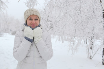 The girl walks in the park in the winter. A portrait on a belt