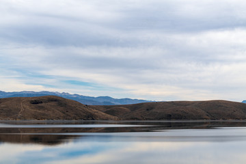 Mountains and sky reflected in Topaz Lake on the Nevada California border, USA