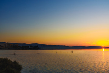 View of sunrise in lagoon Orbetello on peninsula Argentario. Italy