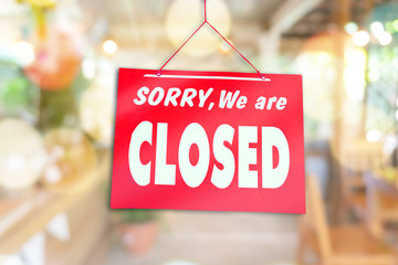 Sorry we are closed sign hang on door of business shop.