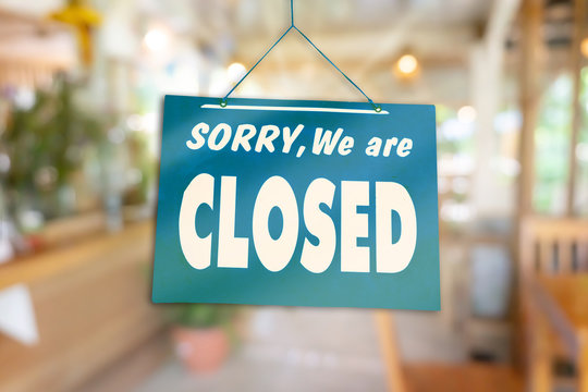 Sorry we are closed sign hang on door of business shop.