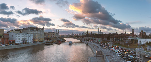 Panorama of beautiful sunset over Moskva river, traffic jam near Kremlin and a touristic boat...