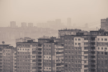 Old russian panel buildings in Vladivostok city, faded background image