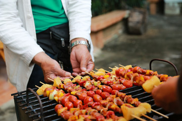 Barbeque Grill Street Food in thailand,Eat outdoors in a happy family.