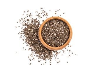Chia seeds in small wooden bowl with some spilled next to it seen from above and isolated on white background