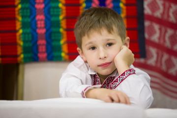 Portrait of a small Belarusian or Ukrainian boy in embroidery.The boy in Slavic clothes
