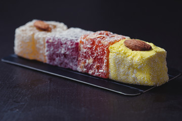 Homemade delicious candied fruit jelly with almonds and coconut flakes. Fruit marmalade.