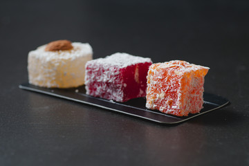 Homemade delicious candied fruit jelly with almonds and coconut flakes. Fruit marmalade.