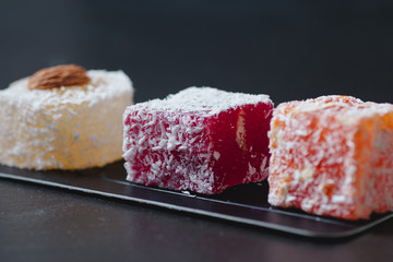 Homemade delicious candied fruit jelly with almonds and coconut flakes. Fruit marmalade.