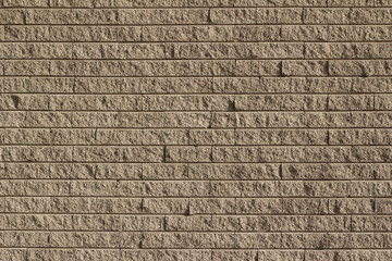 Rough textured tan brown stone brick wall abstract background