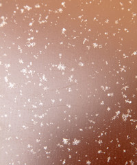 Snowflakes on a brown metallic background