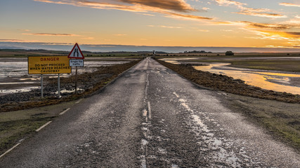 Sign: Single File Traffic, Danger do not proceed when water reaches causeway, seen on the road...