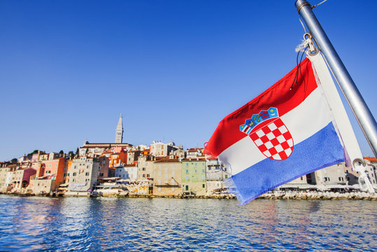 Flag of Croatia with Rovinj town at background, Istria, Croatia. Travel tourism concept. Croatian vacations