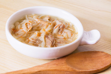 Homemade simple soup in white mug